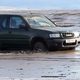 Illustration for article titled Guy parks on the beach and his car ends up swallowed by the tide